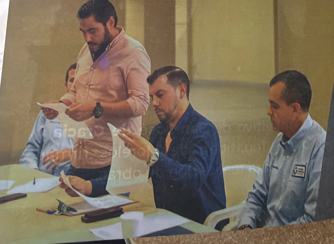 Council members and municipal officials reviewing papers at a table